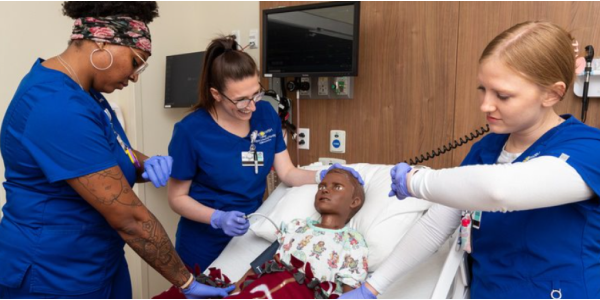 Nurses around a bed